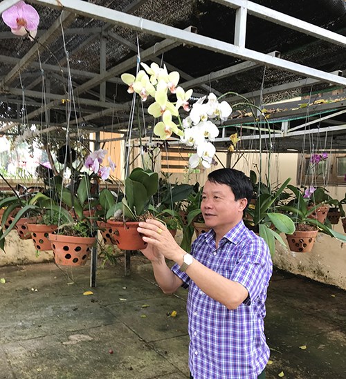 Đại tá Nguyễn Văn Lanh chăm sóc hoa phong lan sau giờ làm việc.